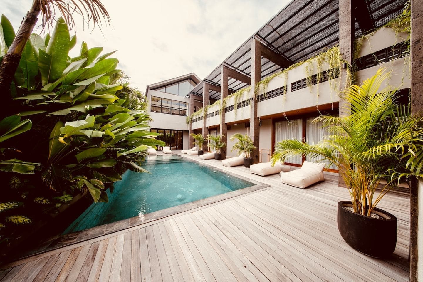 Deluxe Studio — Top floor, elevated view — the Japandi studio with a balcony above the palm line.